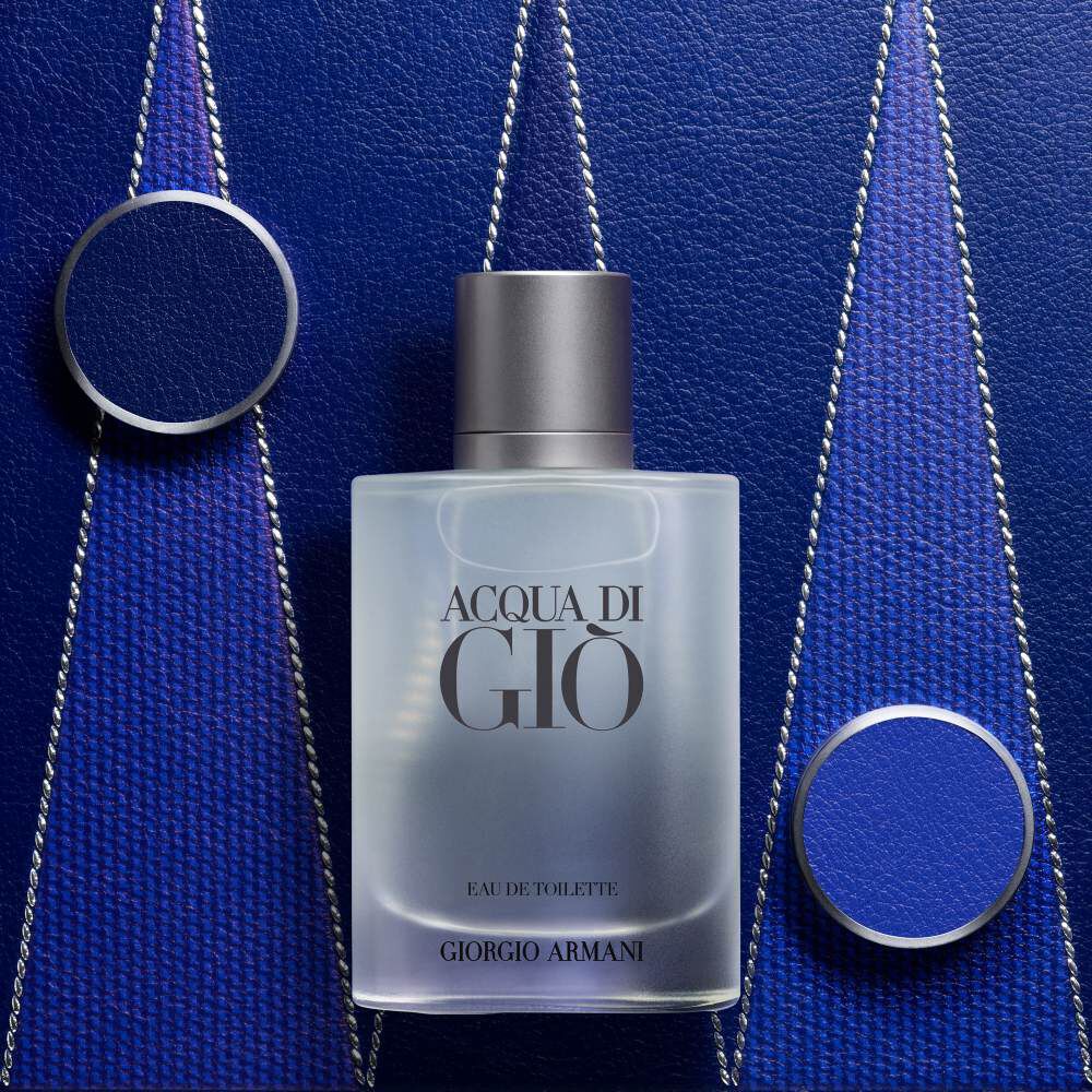 Armani ACQUA DI GIO EAU DE TOILETTE bottle displayed on a textured deep blue Blackgammon background with metallic accents, highlighting the fragrance’s modern, sophisticated, and aquatic identity.