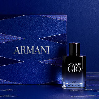 Armani Father's Day gift set featuring an Acqua di Gio Intense fragrance bottle next to a luxurious deep blue leather-textured gift box with silver branding and a geometric backgammon-inspired design.