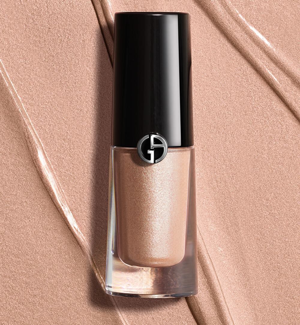 Giorgio Armani Eye Tint liquid eyeshadow in a shimmery rose-gold shade, displayed on a silky copper-toned texture background.