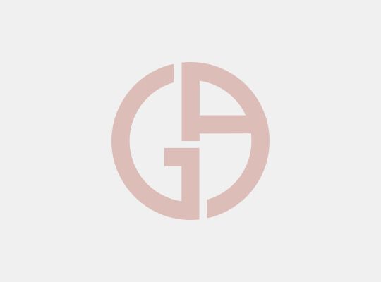 A minimalist logo composed of the letters "G" and "A" intertwined in a circular design, with a soft pink color scheme.