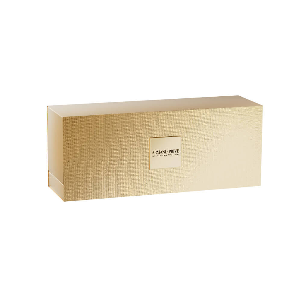 Armani Prive Les Eaux Holiday gift set closed gold rectangular box, photographed on a white background. Luxury packaging designed to hold four fragrance miniatures.