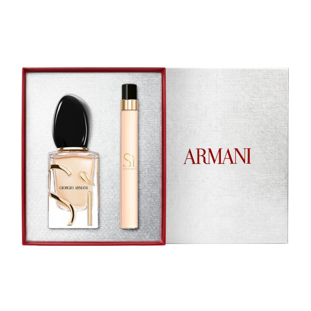 Si Eau de Parfum 30 ml en 10 ml goudkleurige flessen naast een open witte Armani cadeaudoos met rood lint — dames bloemenparfum cadeauset met witte achtergrond.